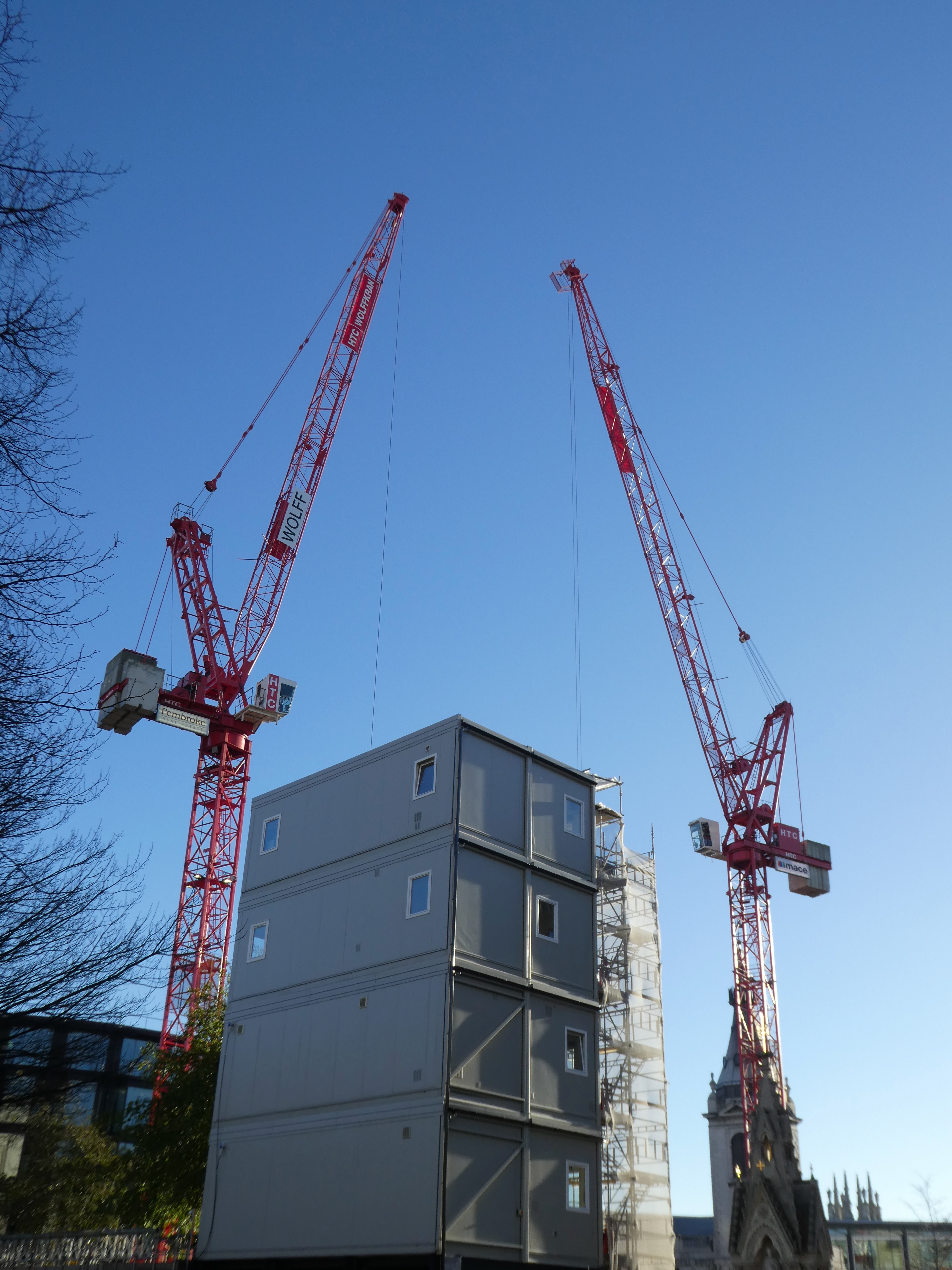 a photo of two construction cranes